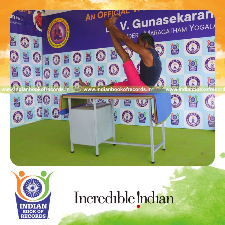 an individual holding vama krounchasana yoga pose on a table for the longest duration with control and flexibility for a record in Indian Book of Records