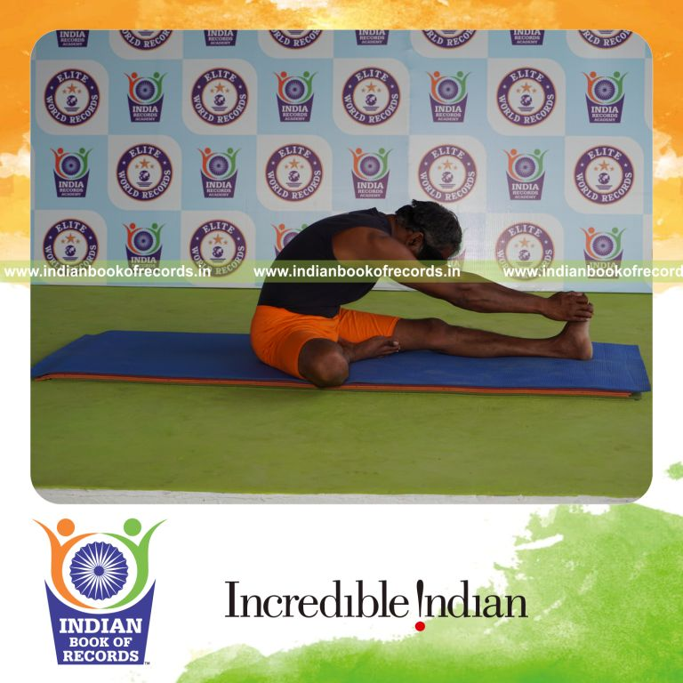individual holding vama mahamudra yoga pose blindfolded for record in Indian Book of Records