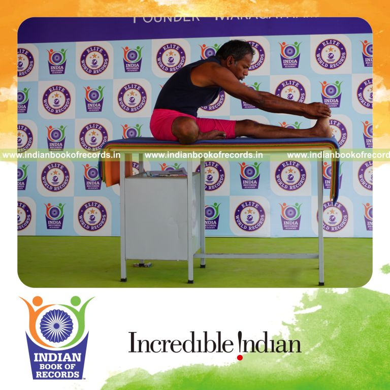 individual holding vama mahamudra yoga pose on a table for record in Indian Book of Records