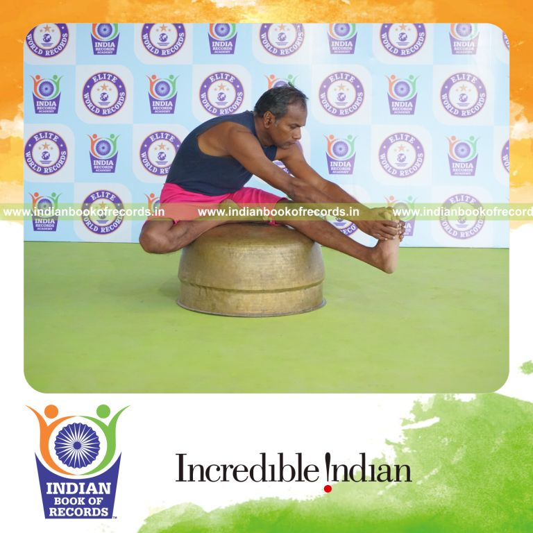 individual holding vama mahamudra yoga pose on a vessel for record in Indian Book of Records