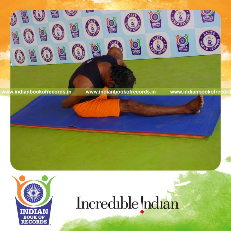 individual holding vama marichyasana yoga pose blindfolded for record in Indian Book of Records