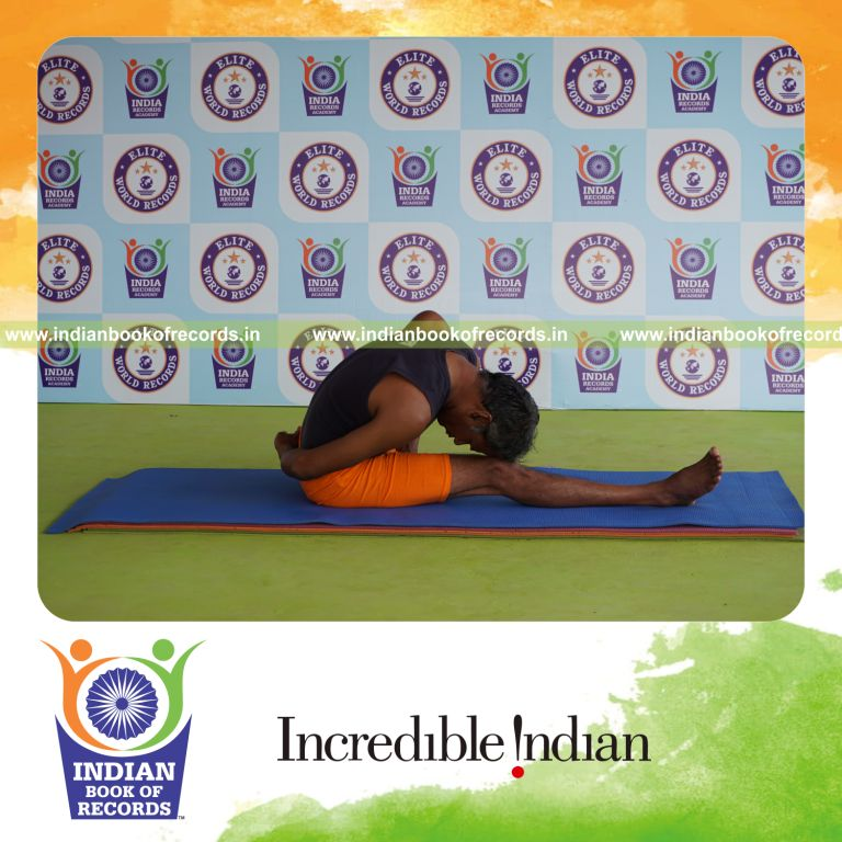 individual holding vama marichyasana yoga pose for record in Indian Book of Records