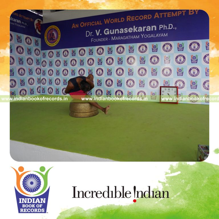 individual holding vama marichyasana yoga pose on a vessel for record in Indian Book of Records