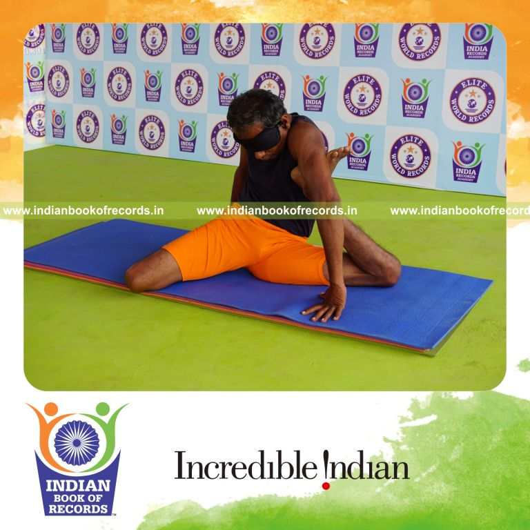 individual holding vama mrigasana yoga pose blindfolded for record in Indian Book of Records