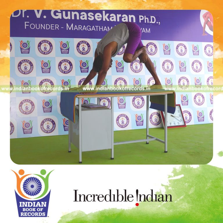 individual holding vama nasika purusta janu parsvasana yoga pose on a table for record in Indian Book of Records