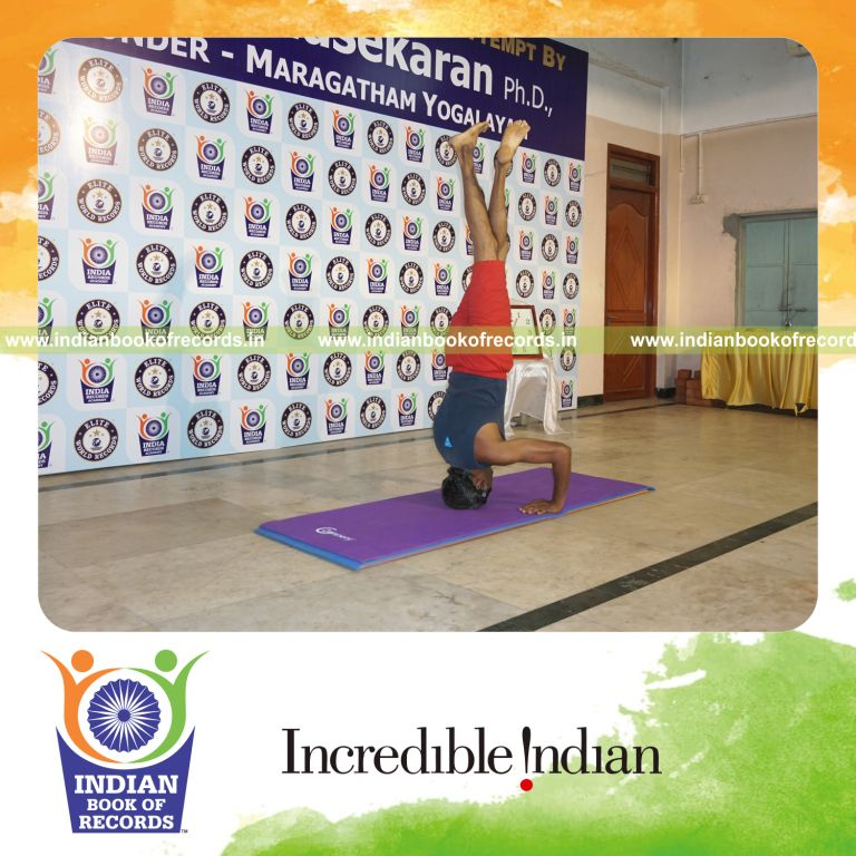 individual holding vama parivrtaikapata salamba sirsasana second type yoga pose blindfolded for record in Indian Book of Records