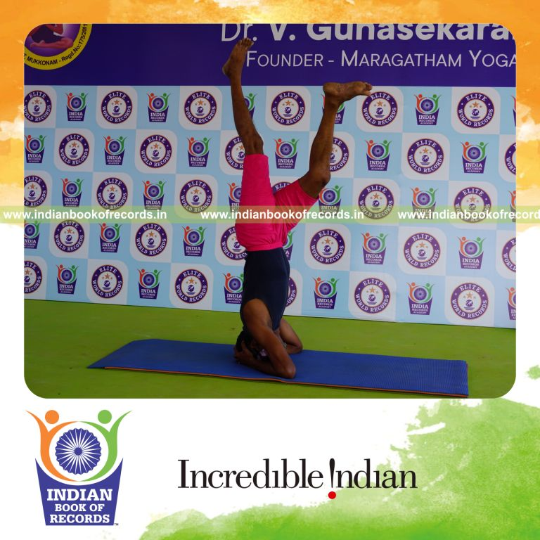 an individual holding vama parivrtaikapata sirsasana yoga pose blindfolded for the longest duration with balance and control for a record in Indian Book of Records
