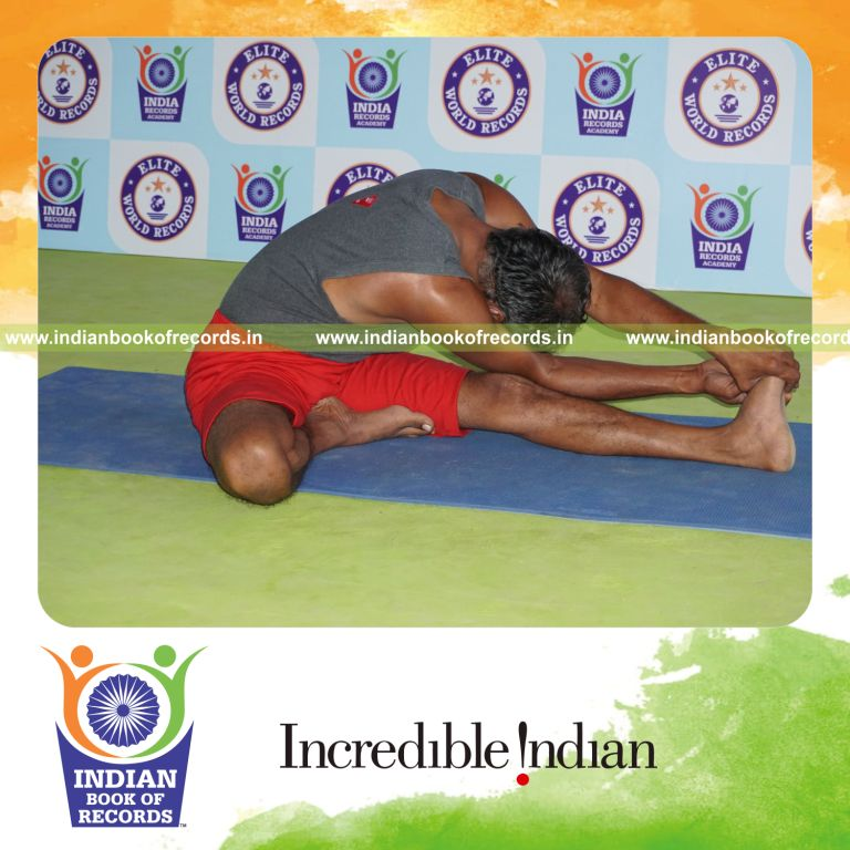 individual holding vama parivrtana janu sirsasana yoga pose for record in Indian Book of Records