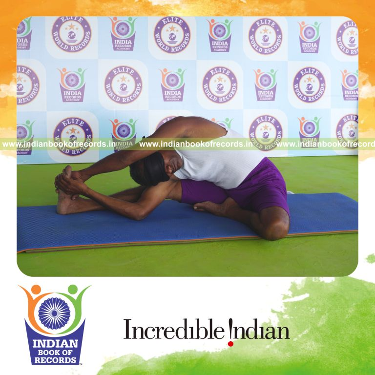 individual holding vama parivrtta janu sirsasana yoga pose blindfolded for record in Indian Book of Records