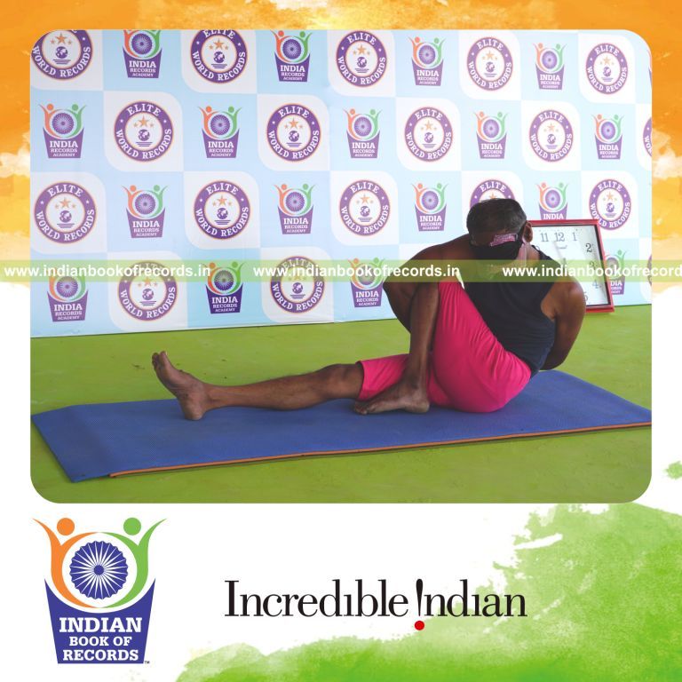 an individual holding vama parivrtta marichyasana yoga pose blindfolded for the longest duration with flexibility and balance for a record in Indian Book of Records