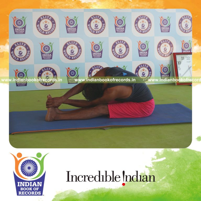individual holding vama parivrtta paschimottanasana yoga pose blindfolded for record in Indian Book of Records