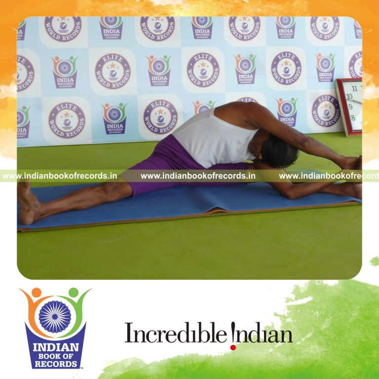 individual holding vama parivrtta upavistha konasana yoga pose blindfolded for record in Indian Book of Records