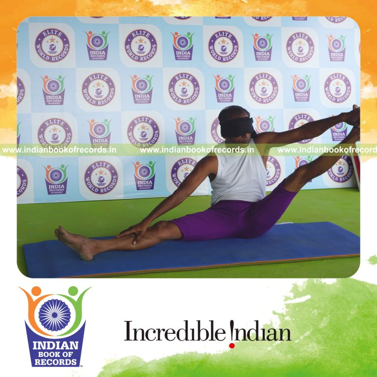 individual holding vama parshwa akarna dhanurasana yoga pose blindfolded for record in Indian Book of Records