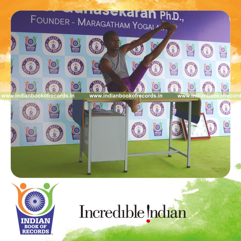 individual holding vama parshwa akarna dhanurasana yoga pose on a table for record in Indian Book of Records