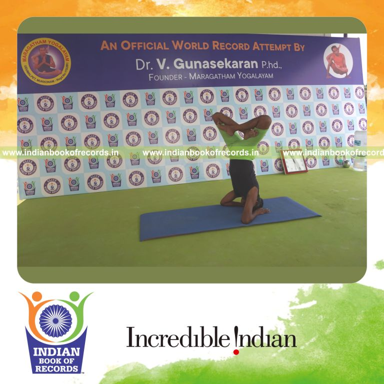 an individual holding vama parsva padma salamba sirsasana yoga pose blindfolded for the longest duration with balance and control for a record in Indian Book of Records