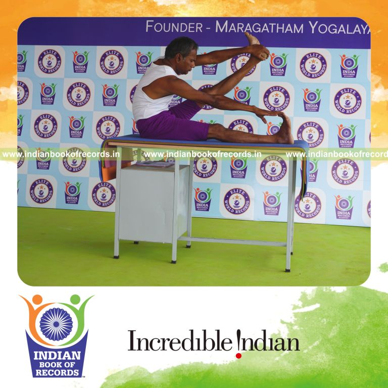 individual holding vama purna akarna dhanurasana yoga pose on a table for record in Indian Book of Records