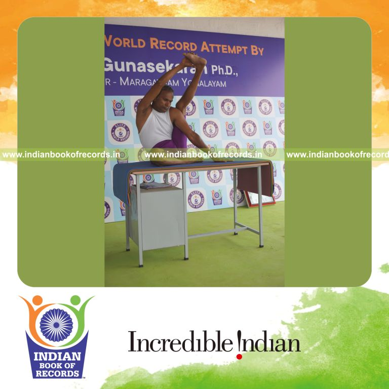 individual holding vama purna krounchasana yoga pose on a table for record in Indian Book of Records