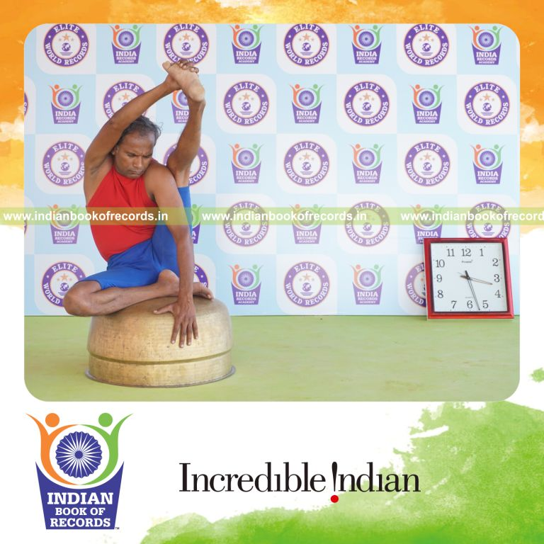 individual holding vama purna krounchasana yoga pose on a vessel for record in Indian Book of Records