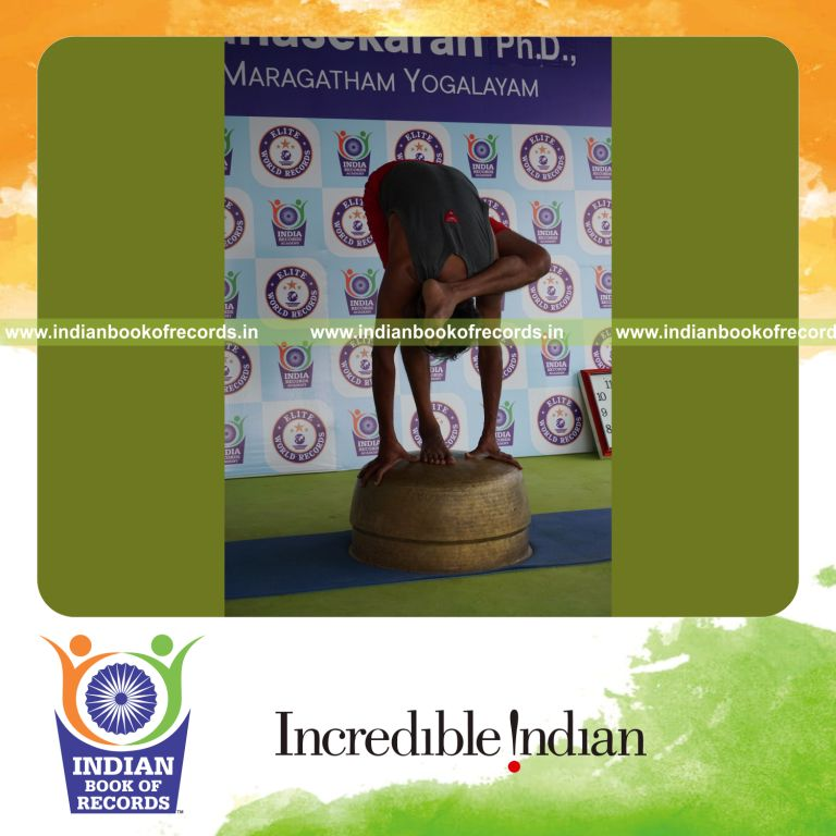 individual holding vama ruchikasana yoga pose blindfolded on a vessel for record in Indian Book of Records