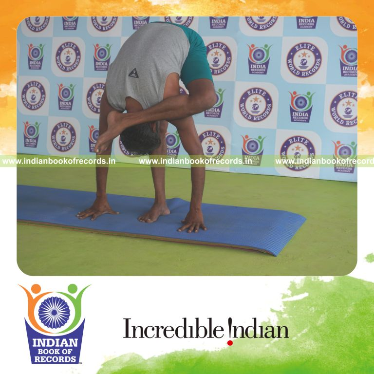 individual holding vama ruchikasana yoga pose for record in Indian Book of Records