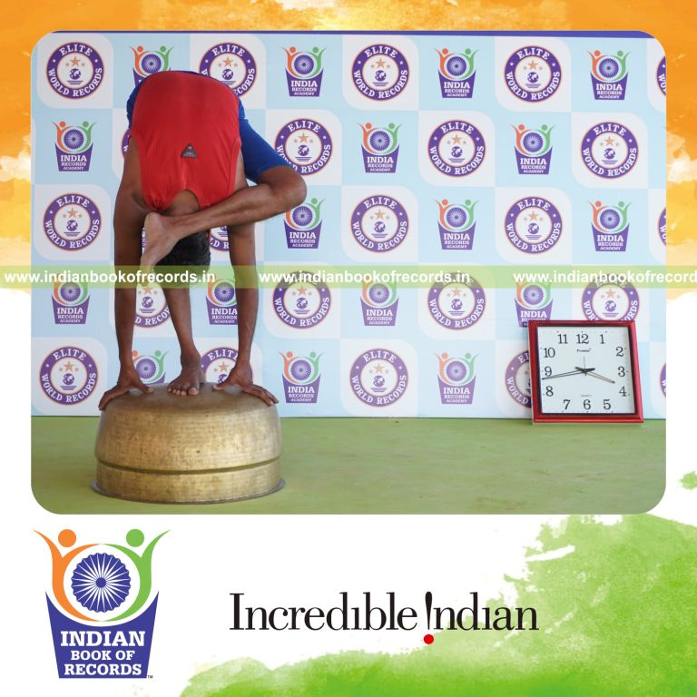 individual holding vama ruchikasana yoga pose on a vessel for record in Indian Book of Records