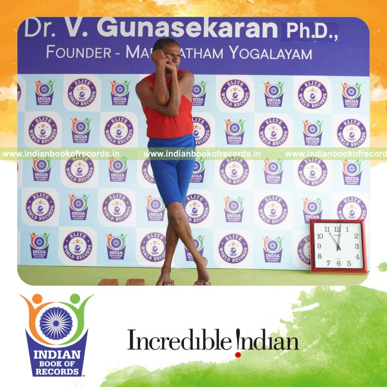 individual holding vama tada garudasana yoga pose on bricks for record in Indian Book of Records