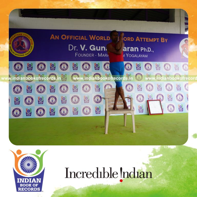 individual holding vama tada garudasana yoga pose on a chair for record in Indian Book of Records