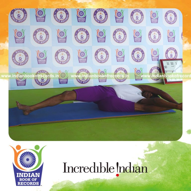 individual holding vama trivikramasana yoga pose blindfolded for record in Indian Book of Records