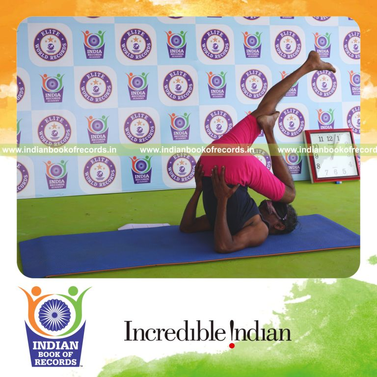 an individual holding vama utthita kadi ekapada chakrasana yoga pose blindfolded for the longest duration with flexibility and balance for a record in Indian Book of Records
