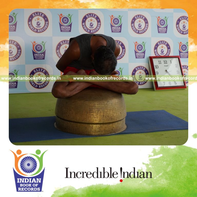 individual holding yoga mudra yoga pose blindfolded on a vessel for record in Indian Book of Records