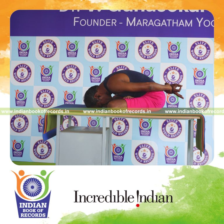 an individual holding yoga mudra yoga pose on a table for the longest duration with control and stability for a record in Indian Book of Records