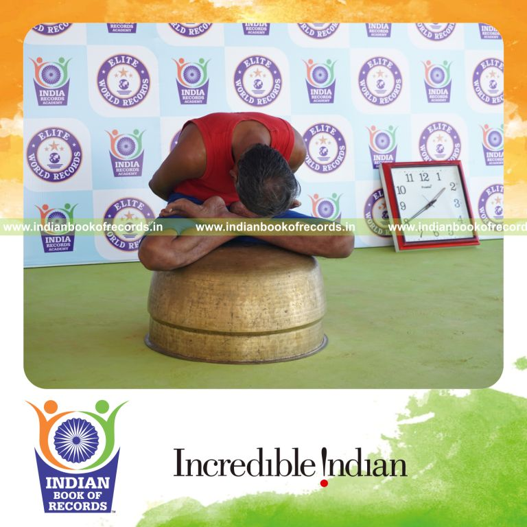 individual holding yoga mudra yoga pose on a vessel for record in Indian Book of Records