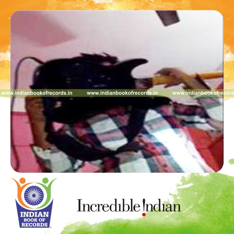 individual playing electric guitar with teeth for longest duration for record in Indian Book of Records
