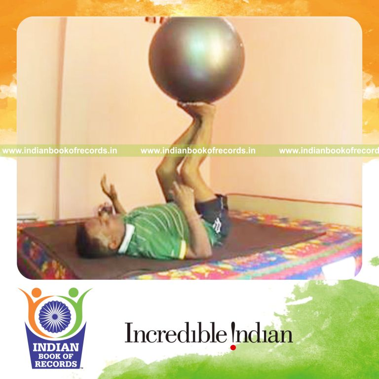 individual balancing exercise ball on soles of feet for record in Indian Book of Records