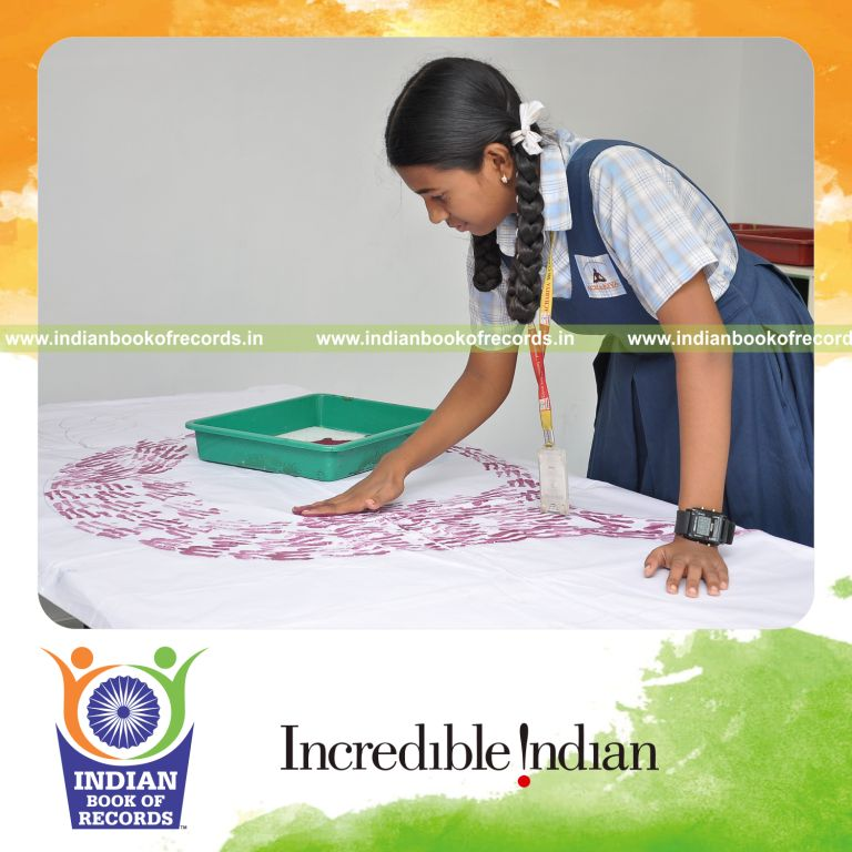 young female creating extended finger painting artwork for record in Indian Book of Records