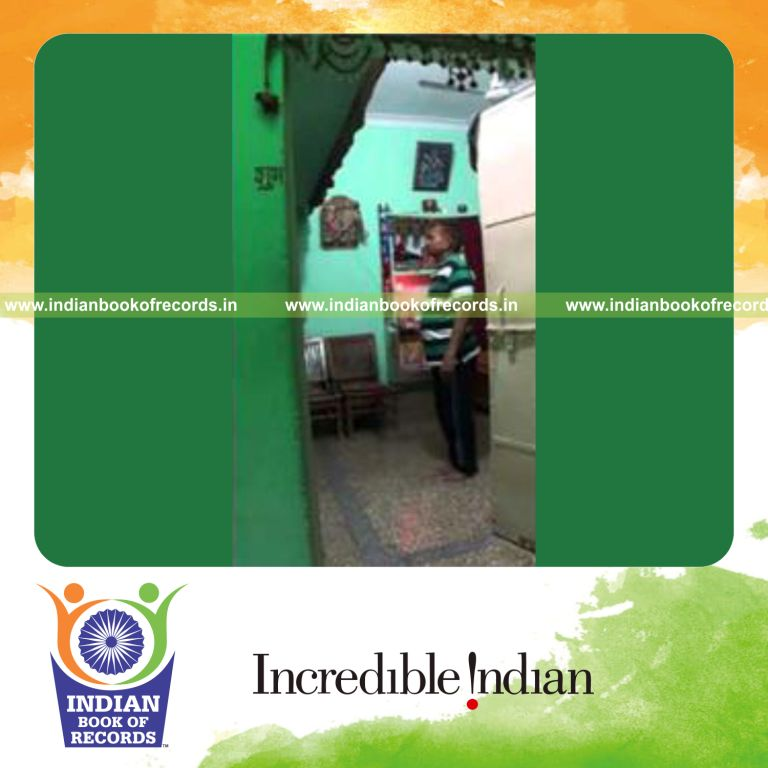 individual balancing five cans on right middle finger for record in Indian Book of Records