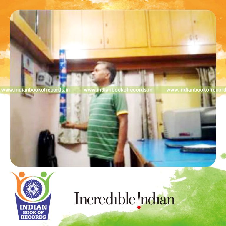 individual balancing five cans on right pinky finger for record in Indian Book of Records