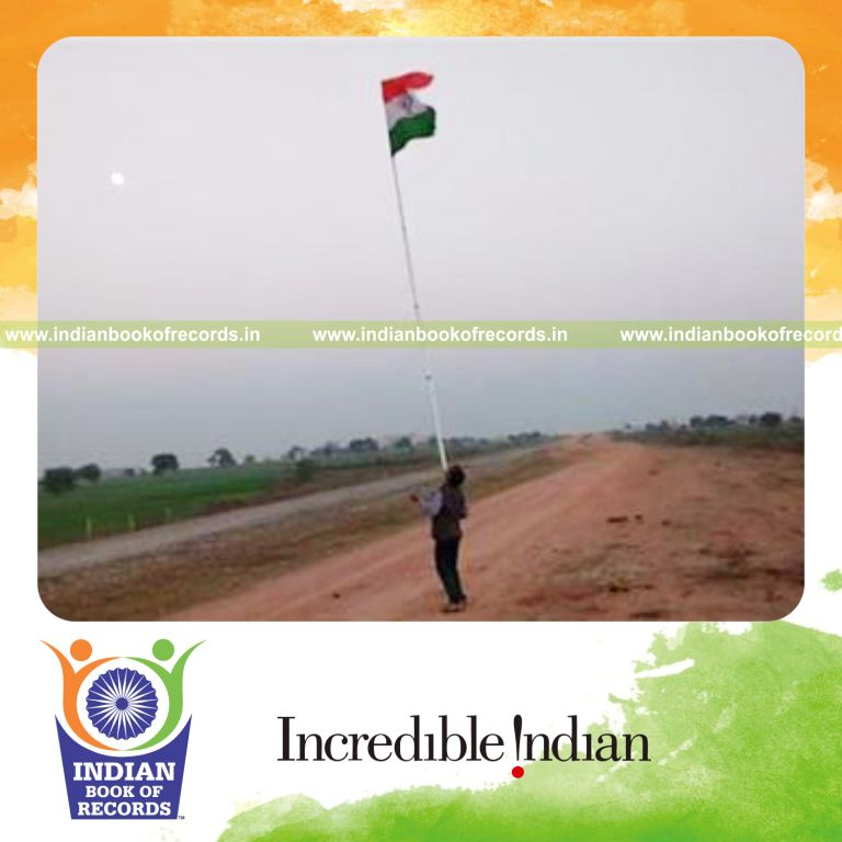 individual balancing Indian national flag on long pole on chin for record in Indian Book of Records