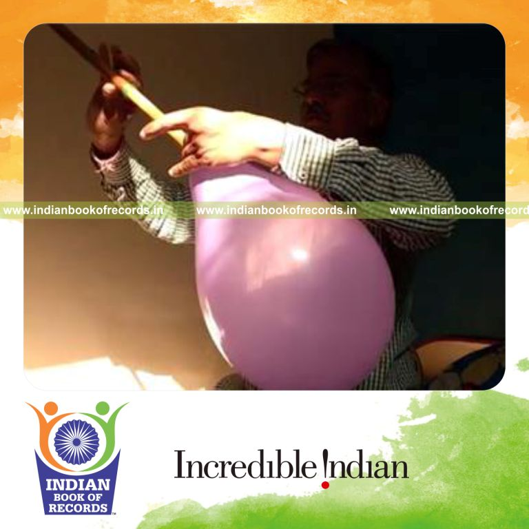 individual playing flute using inflated balloon for longest time for record in Indian Book of Records