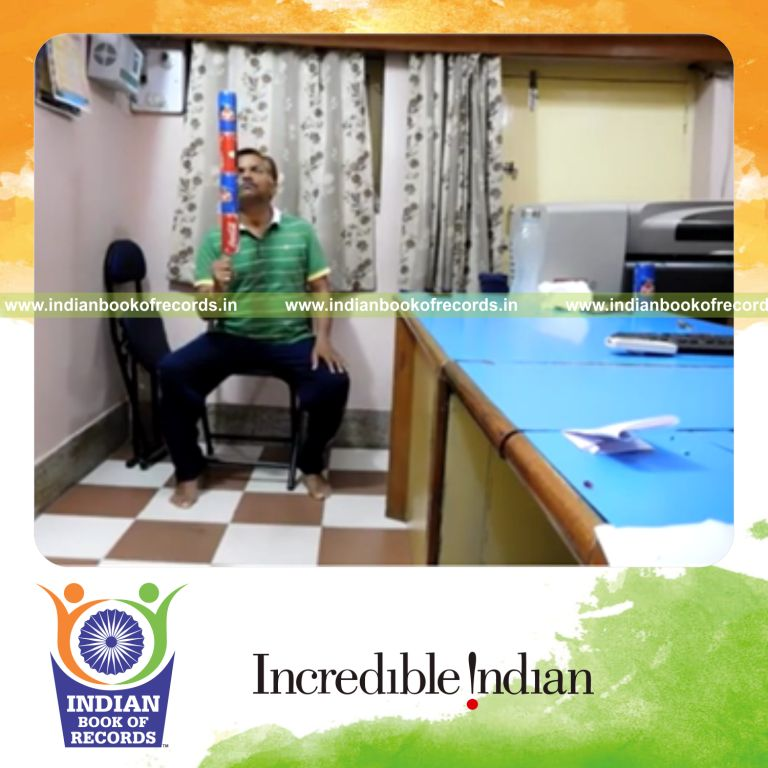 individual balancing four soda cans on thumb for record in Indian Book of Records