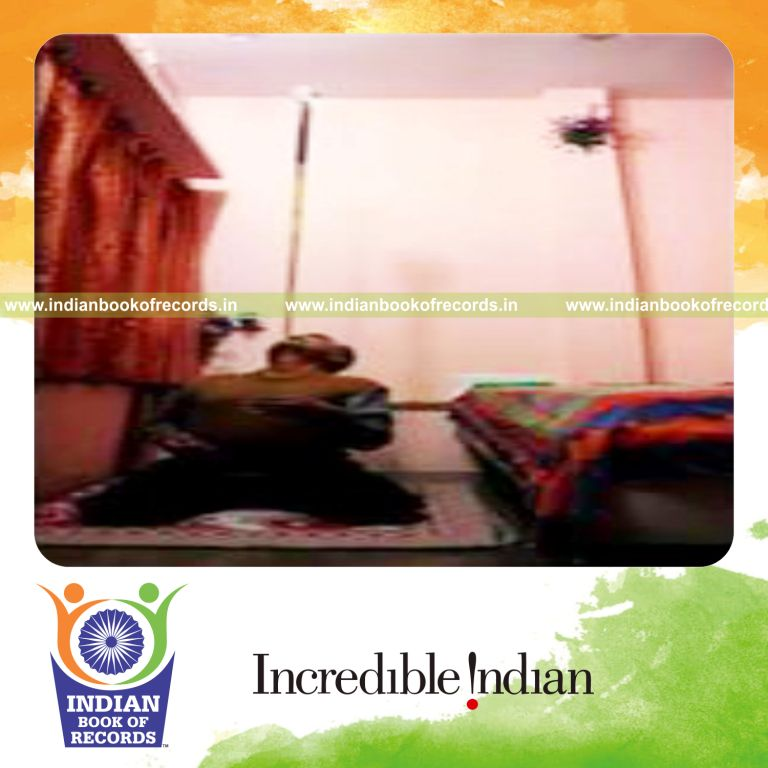 individual balancing glass of water on pool cue on chin for record in Indian Book of Records