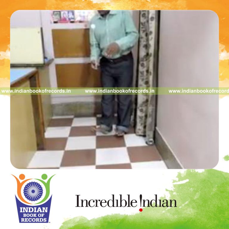 individual balancing golf ball on knitting needle while standing on heels for record in Indian Book of Records