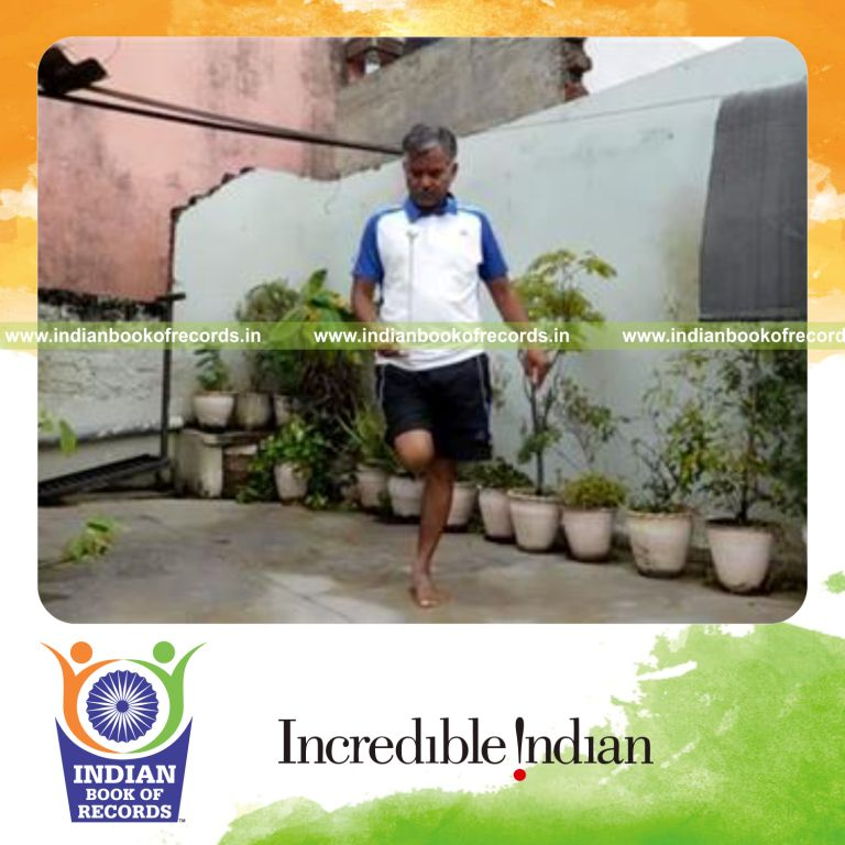 individual balancing golf ball on knitting needle while standing on one leg for record in Indian Book of Records