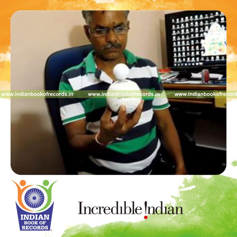 individual balancing golf ball inside softball using fingers for record in Indian Book of Records