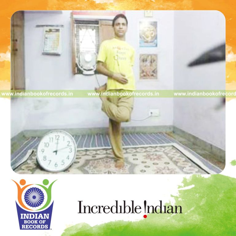 individual holding half locked lotus pose on one leg for record in Indian Book of Records