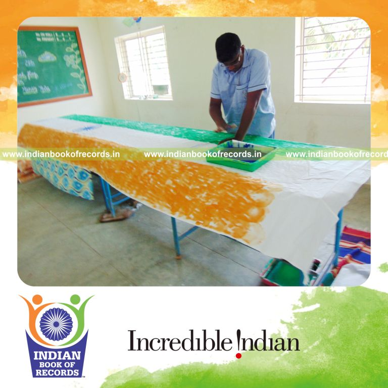 minor male creating indian national flag using handprints for Indian Book of Records