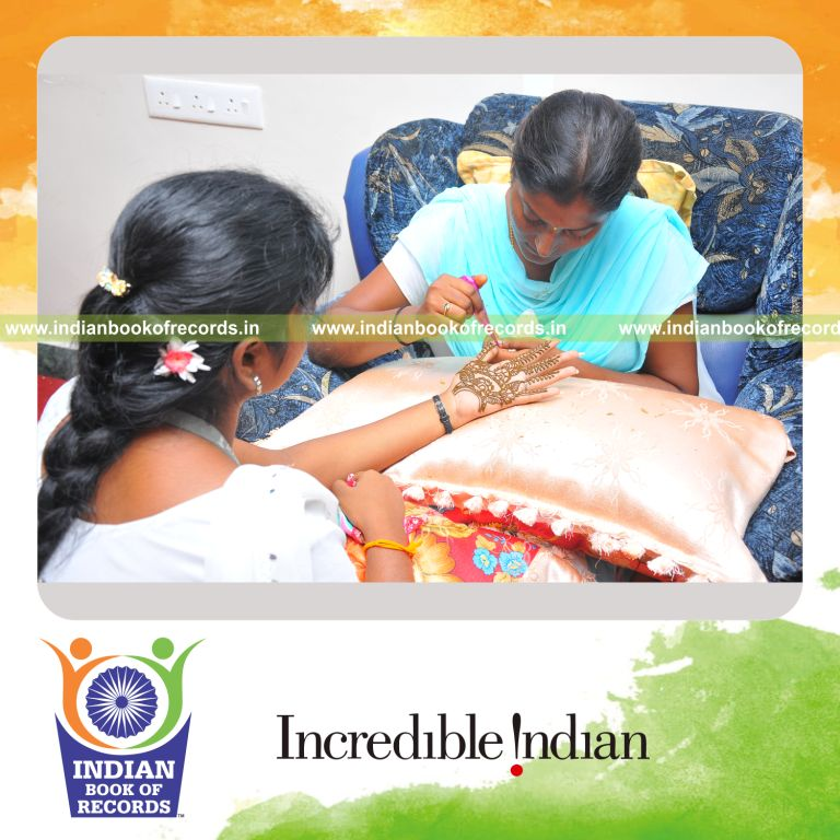 female individual performing extended henna art marathon for record in Indian Book of Records
