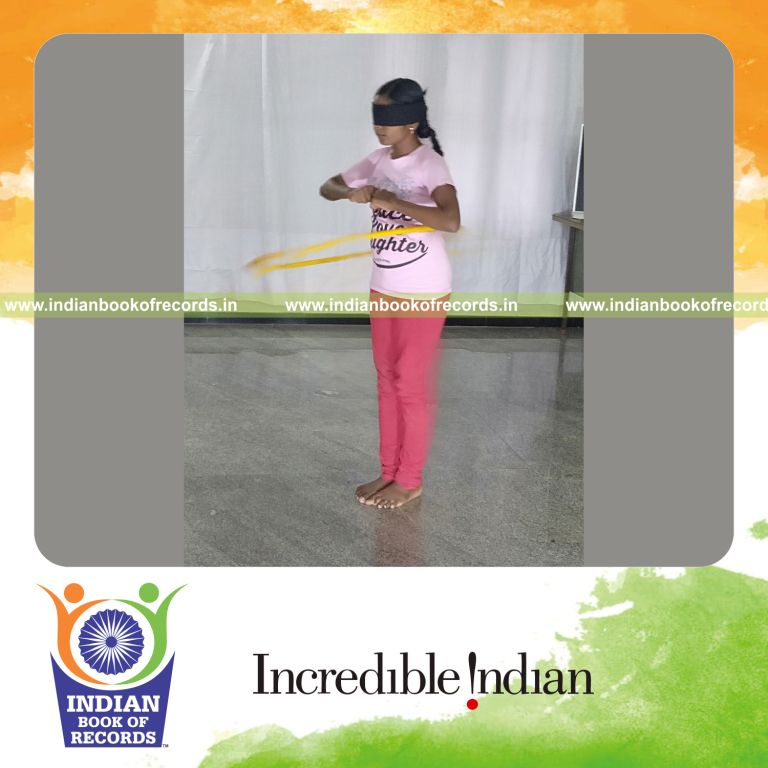 minor female performing hula hoop blindfolded for longest duration for record in Indian Book of Records