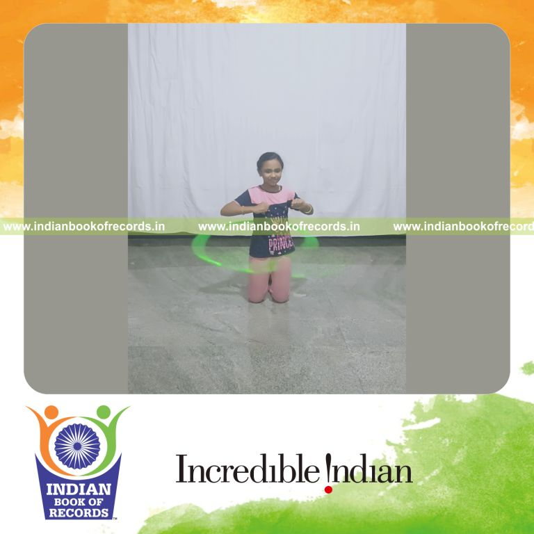 minor female performing hula hoop while kneeling down for longest duration for record in Indian Book of Records