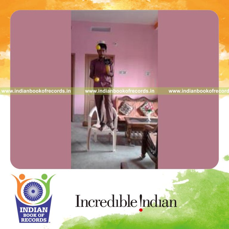 individual juggling stress balls while standing on chair on one foot and balancing items on head for record in Indian Book of Records